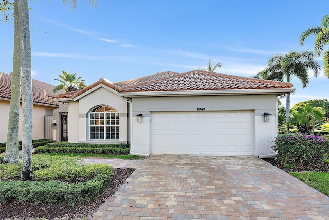 mediterranean / spanish home with a garage