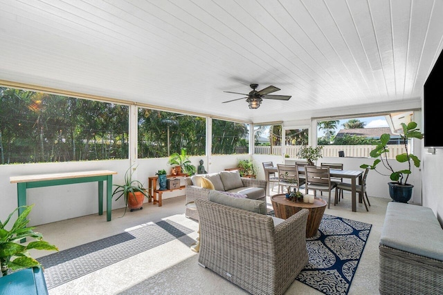 sunroom featuring ceiling fan