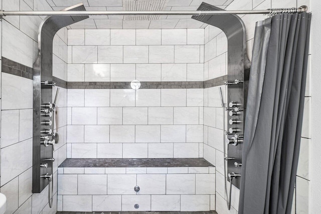 full bathroom with a tile shower