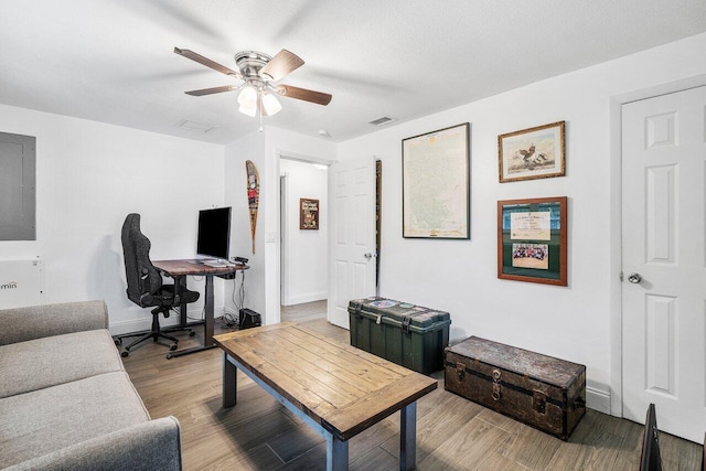 office area featuring baseboards, visible vents, a ceiling fan, wood finished floors, and a textured ceiling