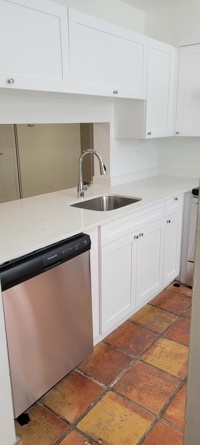 kitchen with sink, white cabinets, and stainless steel dishwasher