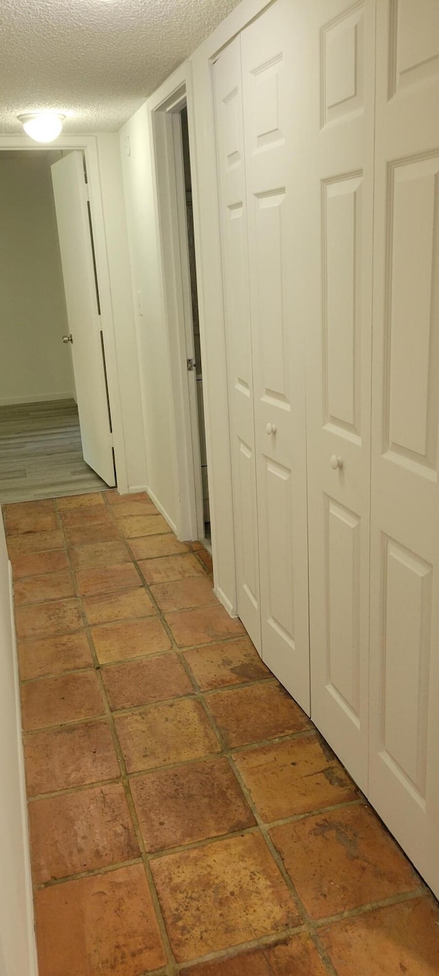 corridor featuring a textured ceiling