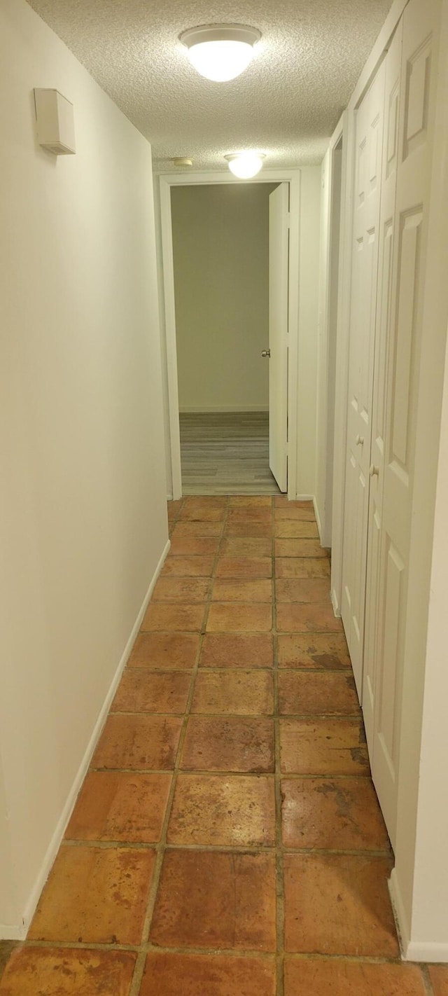 hallway featuring a textured ceiling