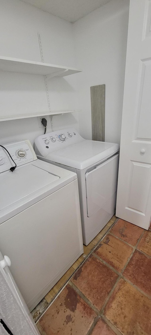 clothes washing area with washer and clothes dryer