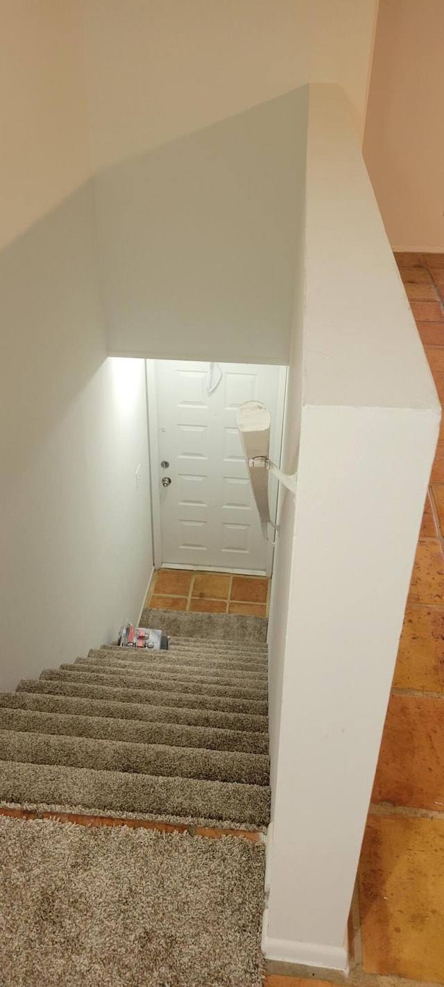 stairway featuring tile patterned floors