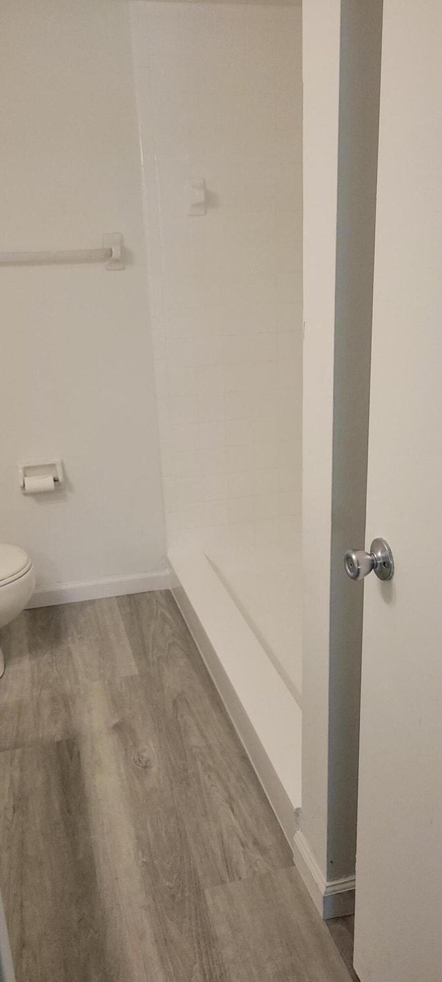 bathroom featuring hardwood / wood-style floors and toilet