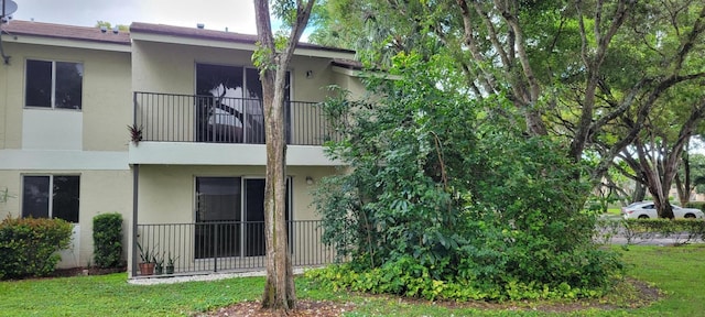 rear view of property with a lawn