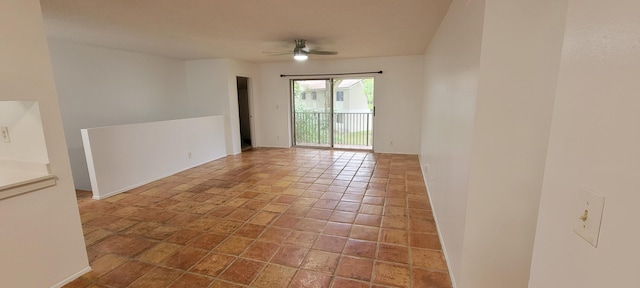 empty room featuring ceiling fan and tile patterned flooring