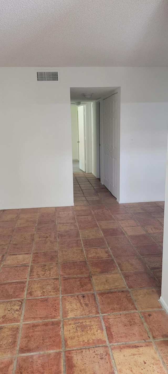 empty room featuring a textured ceiling