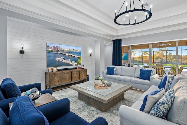 living room with a notable chandelier and ornamental molding