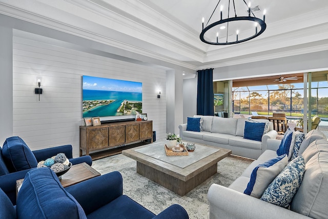 living room featuring crown molding and a chandelier