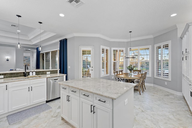 kitchen featuring decorative light fixtures, dishwasher, sink, and a kitchen island