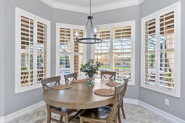 dining space featuring a chandelier and crown molding