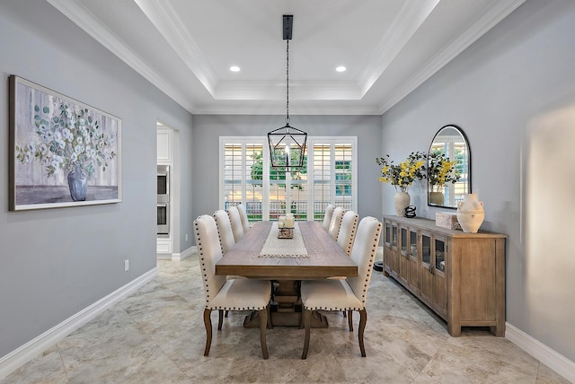 dining area with ornamental molding, a raised ceiling, and an inviting chandelier