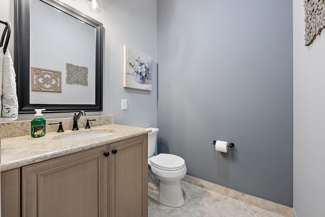 bathroom featuring toilet, vanity, and tile patterned flooring