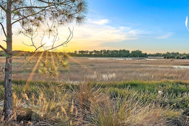 nature at dusk featuring a rural view