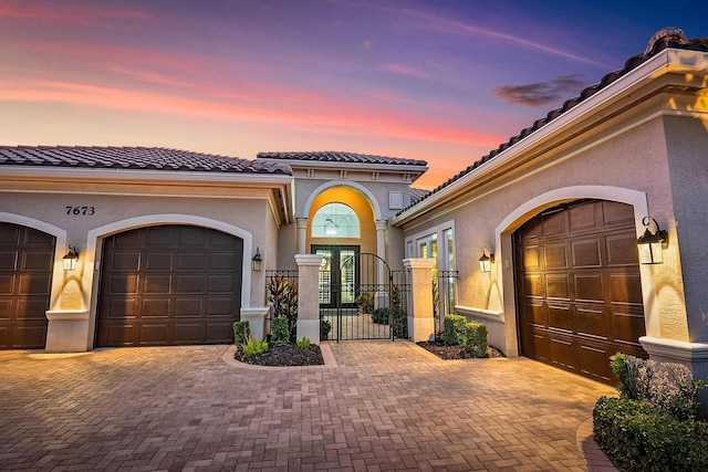 mediterranean / spanish-style home with a garage