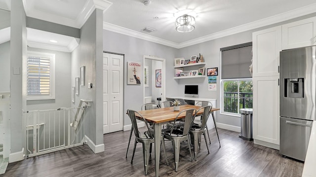 dining area with dark hardwood / wood-style floors and ornamental molding