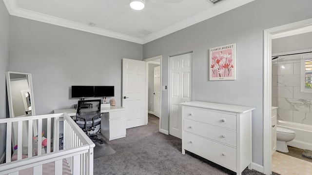 bedroom featuring carpet, ensuite bathroom, ceiling fan, and crown molding