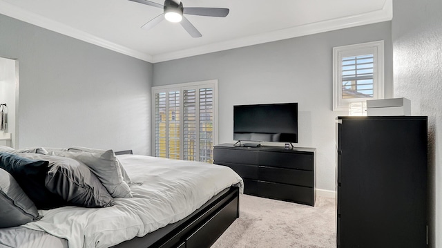 bedroom with ceiling fan, crown molding, and light carpet