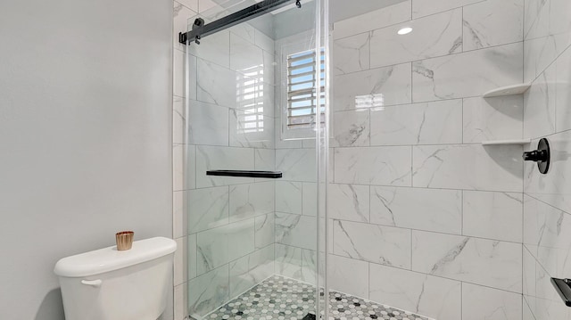 bathroom with an enclosed shower and toilet