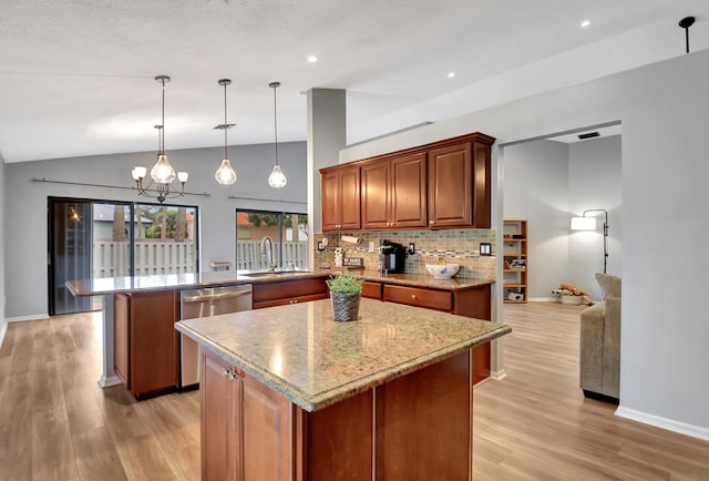 kitchen with dishwasher, a center island, decorative light fixtures, kitchen peninsula, and a notable chandelier