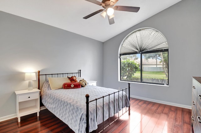 bedroom featuring ceiling fan, dark hardwood / wood-style flooring, and lofted ceiling