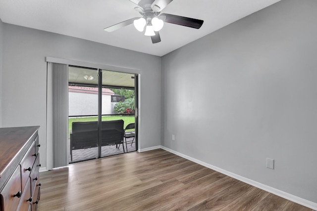 unfurnished room with ceiling fan and wood-type flooring