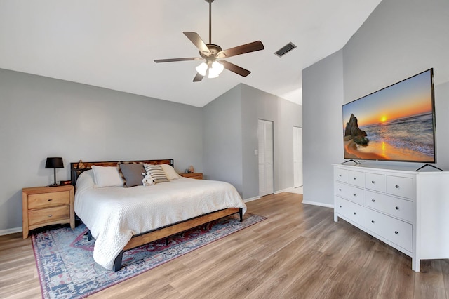 bedroom featuring ceiling fan, light wood-type flooring, and lofted ceiling