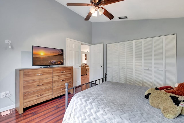 bedroom with dark wood-type flooring, ceiling fan, lofted ceiling, and a closet