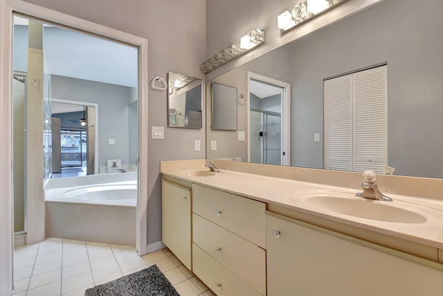 bathroom featuring plus walk in shower, tile patterned floors, and vanity