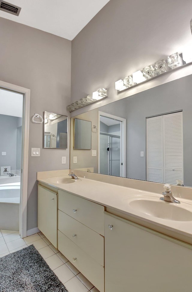 bathroom with vanity, independent shower and bath, and tile patterned flooring