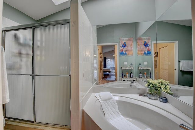 bathroom with lofted ceiling, vanity, and a shower with door