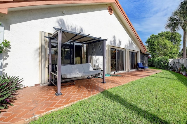 rear view of property with a patio area and a lawn