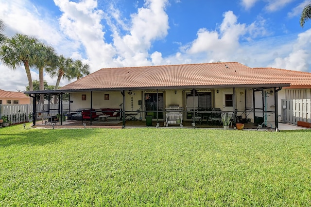 rear view of house featuring a yard and a patio