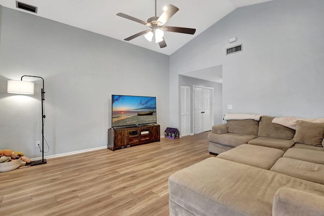 living room with ceiling fan, light hardwood / wood-style flooring, and high vaulted ceiling