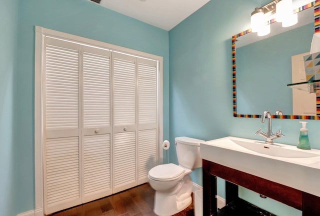 bathroom featuring hardwood / wood-style floors, vanity, and toilet