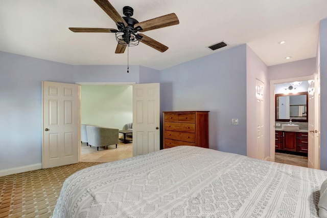 bedroom featuring ceiling fan, sink, and ensuite bathroom