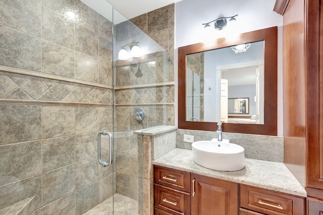 bathroom featuring vanity and an enclosed shower