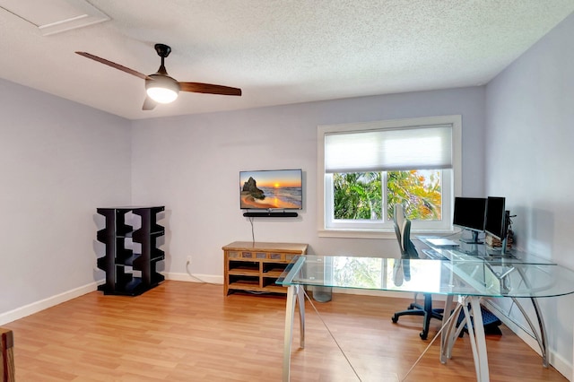 office area with hardwood / wood-style floors, a textured ceiling, ceiling fan, and a healthy amount of sunlight