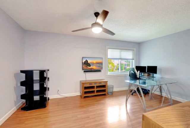 office with ceiling fan, wood-type flooring, and a textured ceiling