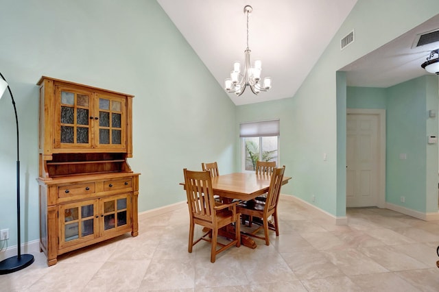 dining area featuring lofted ceiling and a notable chandelier