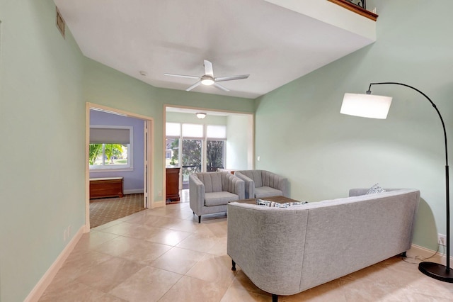 living room with light tile patterned floors and ceiling fan