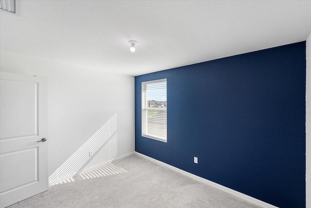 empty room featuring light carpet