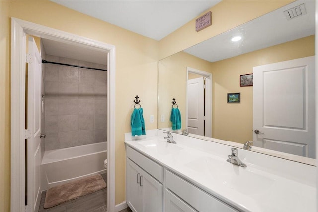 full bathroom with vanity, toilet, and tiled shower / bath combo