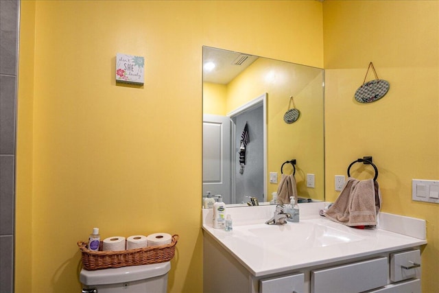 bathroom with vanity and toilet