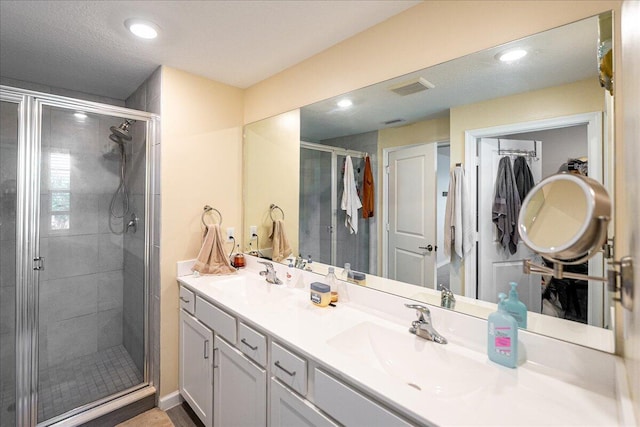 bathroom featuring vanity and a shower with shower door