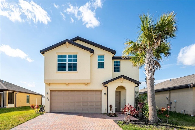 view of front of house featuring a front yard and a garage