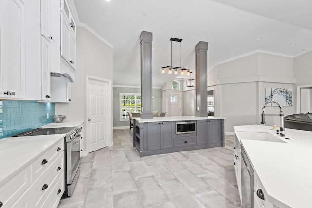 kitchen with appliances with stainless steel finishes, tasteful backsplash, gray cabinetry, white cabinets, and hanging light fixtures