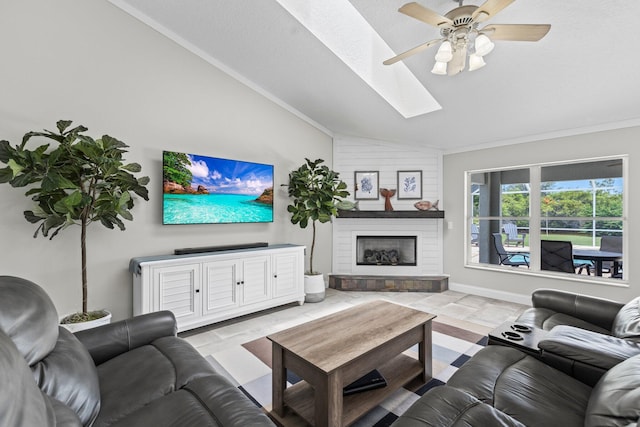 living room featuring ceiling fan, vaulted ceiling with skylight, and crown molding